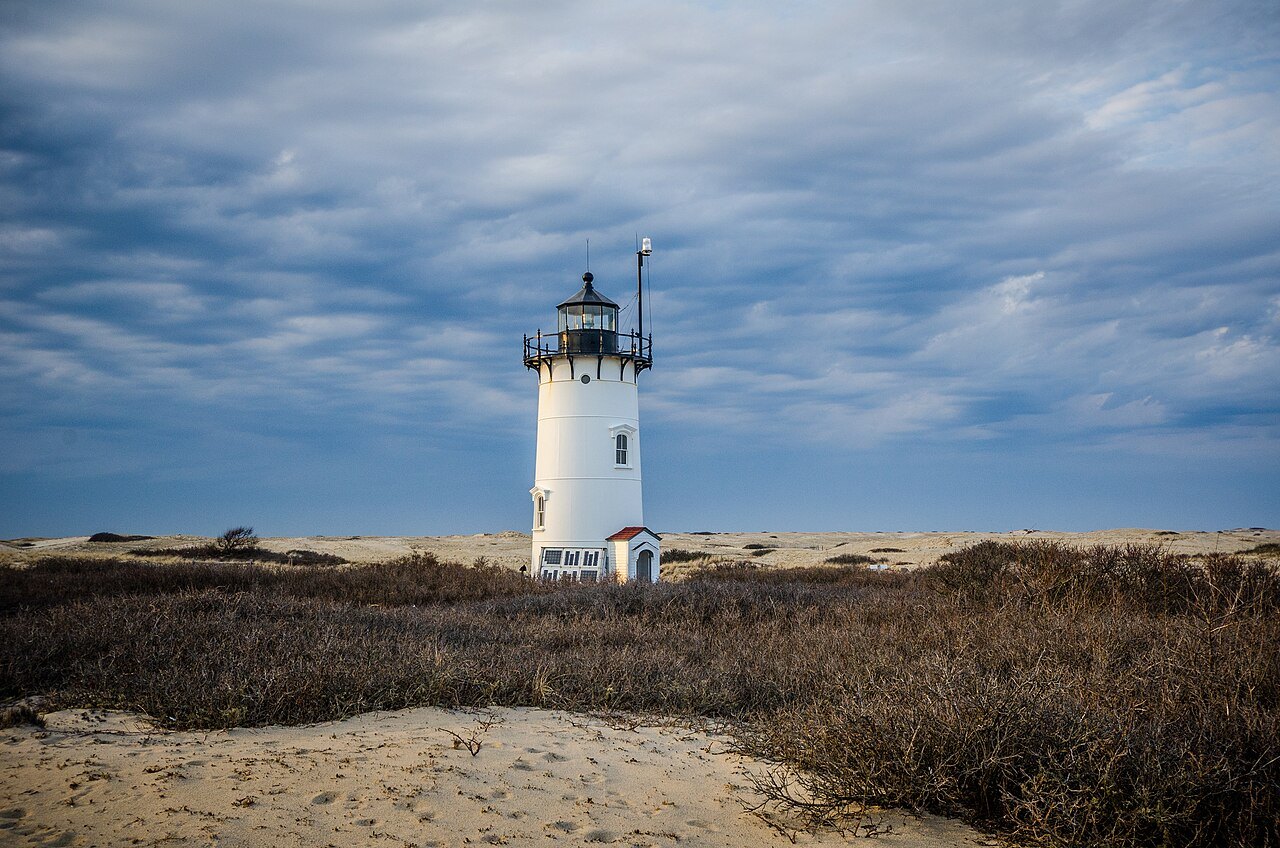 Race Point Light standing alone among the dunes at the tip of the Cape