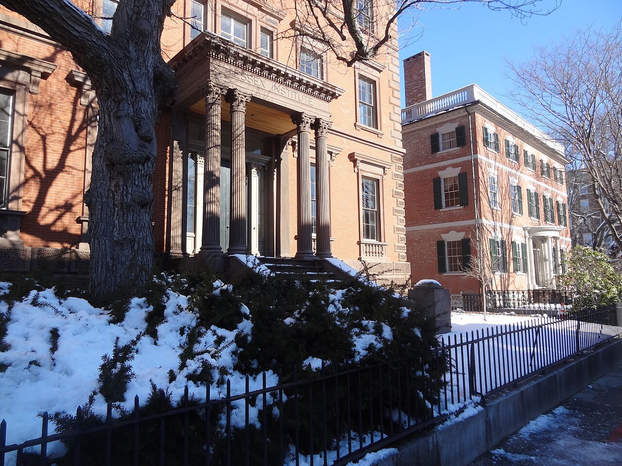 The John Tucker Daland House, its columned porch above a snowy garden