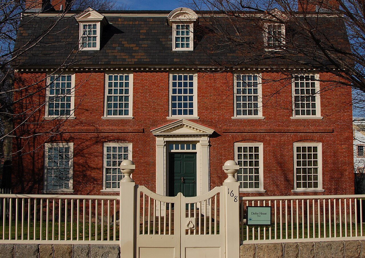 The Derby House, a brick merchant's house behind its white fence and gate