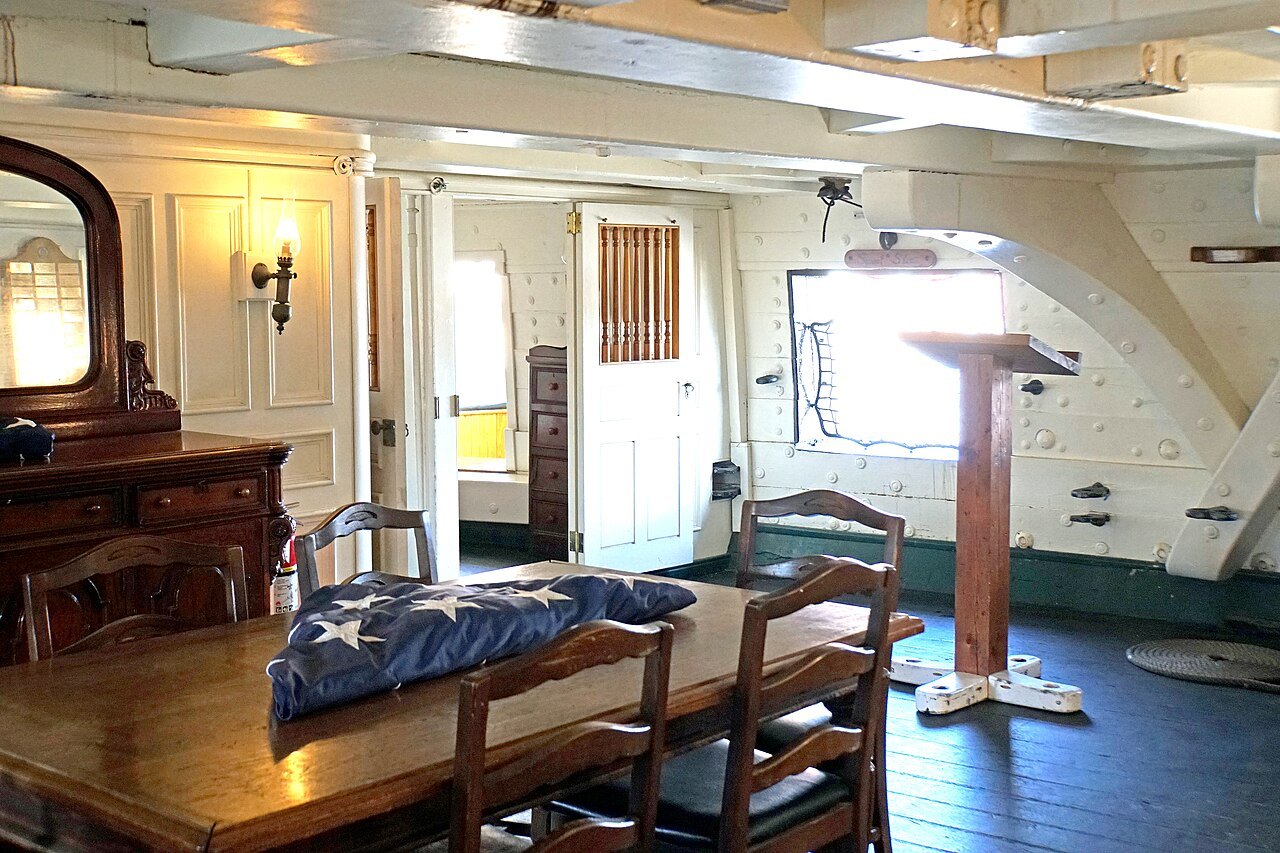 The captain's cabin, a long table set under the stern windows