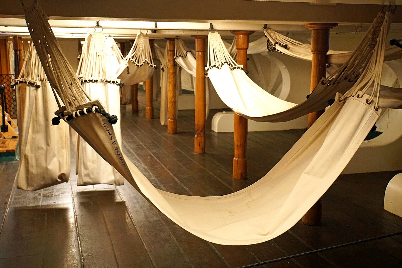 Canvas hammocks slung between the beams of the berth deck, where the crew slept