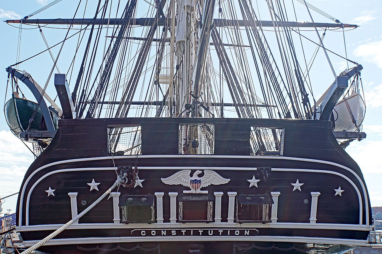 The ornate stern of Old Ironsides, a carved eagle and stars above the ship's name