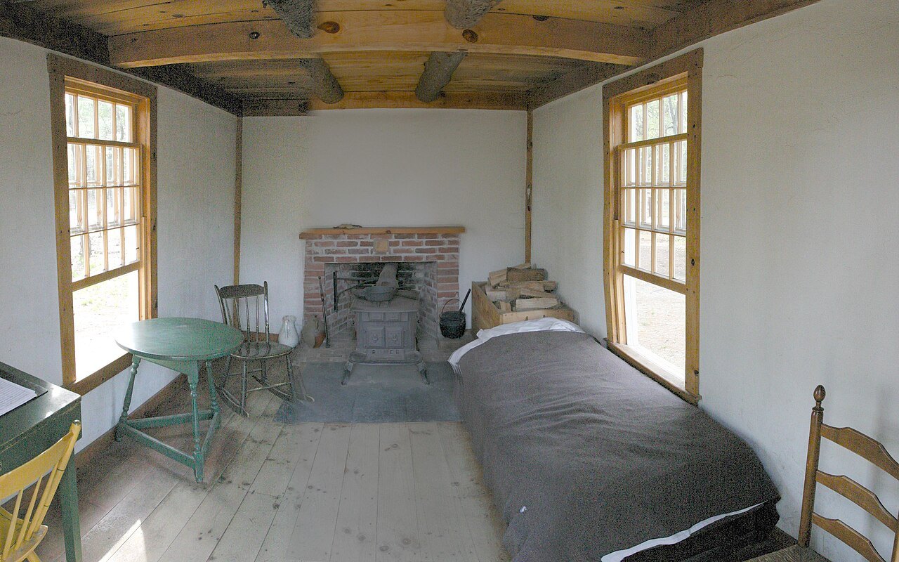 Inside the replica of Thoreau's one-room cabin: a bed, a desk and a small stove